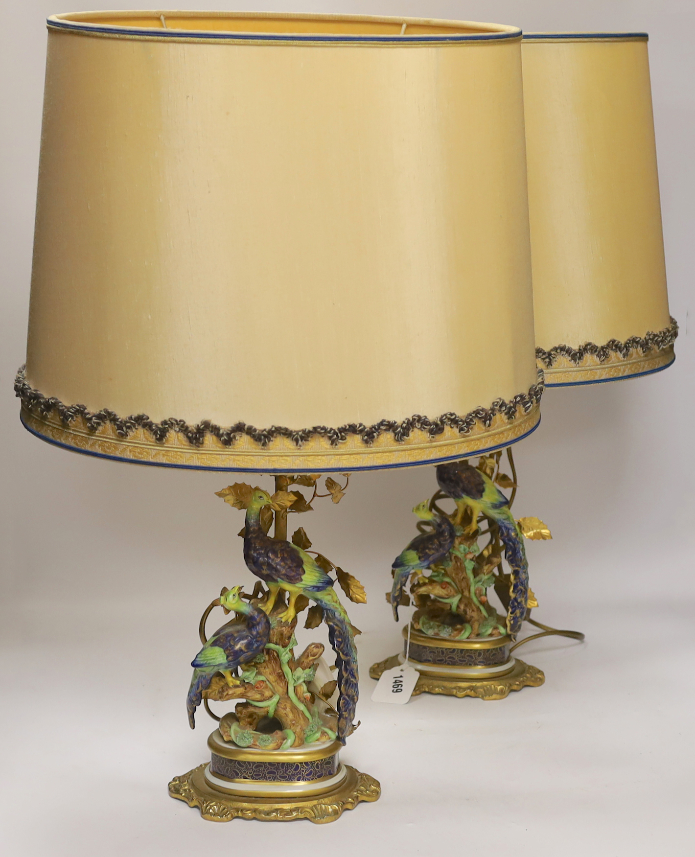 A pair of Sevres style porcelain and gilt metal ‘peacock’ lamps and shades, 60cm total height